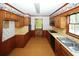 Kitchen with wood cabinets and patterned wallpaper at 2994 Ravenwolfe Way, Snellville, GA 30039