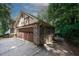 Attached garage with brown door, side yard access at 2994 Ravenwolfe Way, Snellville, GA 30039