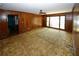 Living room showcasing wood paneling and large windows at 2994 Ravenwolfe Way, Snellville, GA 30039