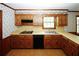 Kitchen with wood cabinets, built-in appliances, and corner sink at 2994 Ravenwolfe Way, Snellville, GA 30039