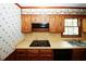 Kitchen features gas cooktop, built-in oven, and double sink at 2994 Ravenwolfe Way, Snellville, GA 30039