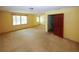 Spacious carpeted bedroom with two windows and an adjacent staircase at 2994 Ravenwolfe Way, Snellville, GA 30039