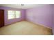 Bedroom with light purple walls and a window at 2994 Ravenwolfe Way, Snellville, GA 30039