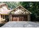 Attached two-car garage with brown door and basketball hoop at 2994 Ravenwolfe Way, Snellville, GA 30039