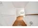 Wooden staircase leading to upper level with stained glass window at 56 17Th Ne St, Atlanta, GA 30309