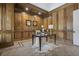 Elegant home office boasts wood paneled walls and herringbone wood floors at 850 Camden Park Ct, Atlanta, GA 30342