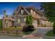 Elegant brick home with stone accents, landscaped yard, and a long driveway at 850 Camden Park Ct, Atlanta, GA 30342