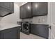 Modern laundry room with dark cabinetry, quartz countertops, and LG appliances at 850 Camden Park Ct, Atlanta, GA 30342