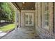 Covered back porch with stone flooring and French doors at 850 Camden Park Ct, Atlanta, GA 30342