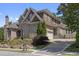 Brick house with stone accents, landscaping, and a long driveway at 850 Camden Park Ct, Atlanta, GA 30342