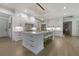 Open concept kitchen with white cabinetry, a large island, and hardwood floors at 850 Camden Park Ct, Atlanta, GA 30342