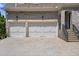 Three-car garage with light beige doors and a concrete driveway at 850 Camden Park Ct, Atlanta, GA 30342