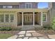 Stone patio with a covered porch and lush landscaping at 850 Camden Park Ct, Atlanta, GA 30342