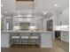 Spacious kitchen island with seating, white cabinets and a statement light fixture at 850 Camden Park Ct, Atlanta, GA 30342