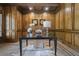 Spacious home office with wood paneled walls, herringbone floors, and large windows at 850 Camden Park Ct, Atlanta, GA 30342