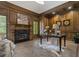 Spacious home office with wood paneled walls, fireplace, and herringbone floors at 850 Camden Park Ct, Atlanta, GA 30342