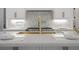 Close-up of kitchen island with marble countertop and gold faucet at 850 Camden Park Ct, Atlanta, GA 30342