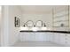 Elegant bathroom with double vanity, black marble countertop, and glass shelving at 850 Camden Park Ct, Atlanta, GA 30342