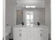 Modern bathroom with double vanity and large mirror at 3325 Piedmont Rd # 2203, Atlanta, GA 30305