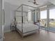 Bright bedroom with a canopy bed, city view, and hardwood floors at 3325 Piedmont Rd # 2203, Atlanta, GA 30305