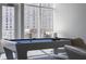 Modern game room with pool table and outdoor access at 3325 Piedmont Rd # 2203, Atlanta, GA 30305