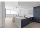 Modern kitchen with white quartz island and dark blue cabinetry at 3325 Piedmont Rd # 2203, Atlanta, GA 30305