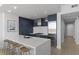 Modern kitchen with white quartz island and dark blue cabinetry at 3325 Piedmont Rd # 2203, Atlanta, GA 30305