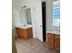 Double vanity bathroom with wood cabinets and tile floor at 635 Beddick Ln, Atlanta, GA 30349