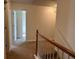 Upstairs hallway with carpeted flooring and access to bedrooms at 635 Beddick Ln, Atlanta, GA 30349