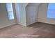 Bright bedroom with carpet flooring and two windows at 635 Beddick Ln, Atlanta, GA 30349