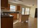 Kitchen features wood cabinets, an island, and tile flooring at 635 Beddick Ln, Atlanta, GA 30349