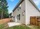 Home's rear exterior showcasing a patio and fenced backyard at 1054 Valley Rock Dr, Lithonia, GA 30058