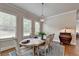 Bright dining room with hardwood floors and a wooden table at 1988 Skybrooke Ct, Hoschton, GA 30548