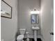 Small powder room with pedestal sink and updated fixtures at 1988 Skybrooke Ct, Hoschton, GA 30548