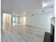 Spacious living room with light gray walls, wood-look floors, and a fireplace at 14 Saint Claire Ne Ln, Atlanta, GA 30324