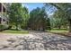 Landscaped entrance to the community with a paved road and lush greenery at 131 Bowen Sw Cir, Atlanta, GA 30315