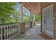 Inviting front porch with brick columns and white railing, overlooking a landscaped yard at 131 Bowen Sw Cir, Atlanta, GA 30315