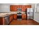 Kitchen boasts wood cabinets, granite countertops, and stainless steel appliances at 131 Bowen Sw Cir, Atlanta, GA 30315