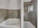 Bathroom with a large soaking tub and walk-in shower at 745 Fountainhead Ne Ln # 113, Atlanta, GA 30324