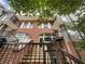 Front view of brick townhome with stairs and wrought iron railing at 745 Fountainhead Ne Ln # 113, Atlanta, GA 30324