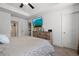 Primary bedroom with large TV and ensuite bathroom access at 2314 Rolling Trl, Lithonia, GA 30058