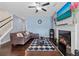 Living room with fireplace, hardwood floors, and large TV at 2314 Rolling Trl, Lithonia, GA 30058