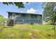 Back of house with wooden stairs, AC unit, and a grassy yard at 166 Rustin Dr, Dallas, GA 30157