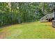 Spacious backyard with wooden deck and lush trees at 166 Rustin Dr, Dallas, GA 30157