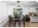 Bright dining area with a wooden table and chairs, adjacent to kitchen at 166 Rustin Dr, Dallas, GA 30157