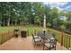 Large backyard with deck, patio furniture, and lush greenery at 680 Swan Dr, Hiram, GA 30141