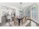 Bright dining room features a dark wood table with seating for six and a view into the kitchen at 6515 Wesley Hughes Rd, Cumming, GA 30040