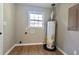 Laundry room with vinyl flooring, new water heater, and built in shelving at 6733 Walker Rd, Riverdale, GA 30296