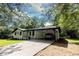 White ranch house with carport and landscaped yard at 6733 Walker Rd, Riverdale, GA 30296