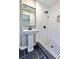 Updated bathroom with subway tile shower and black accents at 6733 Walker Rd, Riverdale, GA 30296